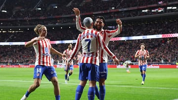 Atletico Madrid's Argentine midfielder #23 Nico Gonzalez celebrates scoring his team's second goal with Atletico Madrid's French forward #07 Antoine Griezmann during the Spanish league football match between Club Atletico de Madrid and Real Sociedad at Metropolitano Stadium in Madrid on March 7, 2026. (Photo by Thomas COEX / AFP)