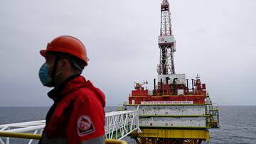 FILE PHOTO: An employee is seen at an oil platform operated by Lukoil company at the Kravtsovskoye oilfield in the Baltic Sea, Russia September 16, 2021. REUTERS/Vitaly Nevar/File Photo