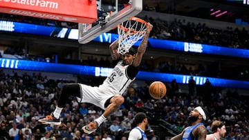 Mar 31, 2025; Dallas, Texas, USA; Brooklyn Nets guard Keon Johnson (45) dunks the ball past Dallas Mavericks guard Jaden Hardy (1) during the second half at the American Airlines Center. Mandatory Credit: Jerome Miron-Imagn Images