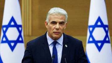 FILE PHOTO: Israeli Foreign Minister Yair Lapid speaks next to Prime Minister Naftali Bennett (not pictured) as they give a statement at the Knesset, Israel's parliament, in Jerusalem, June 20, 2022. REUTERS/Ronen Zvulun/File Photo