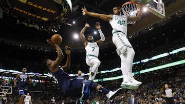 Jan 5, 2018; Boston, MA, USA; Minnesota Timberwolves guard Jimmy Butler (23) tries to shoot over Boston Celtics forward Al Horford (42) and guard Jaylen Brown (7) while falling during the first half at TD Garden. Mandatory Credit: Winslow Townson-USA TODAY Sports