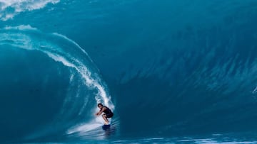 A surfer rides a wave as a big swell hits Teahupoo, Tahiti on April 30, 2023. (Photo by Brian Bielmann / AFP) / RESTRICTED TO EDITORIAL USE