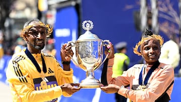 Athletics - The 128th Boston Marathon - Boston, Massachusetts, U.S. - April 15, 2024  Ethiopia's Sisay Lemma and Kenya's Hellen Obiri pose with the trophy after winning the men's and women's elite races REUTERS/Ken Mcgagh