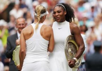 Serena Williams of The United States and Angelique Kerber of Germany in conversation as they hold their trophies following The Ladies Singles Final on day twelve of the Wimbledon Lawn Tennis Championships at the All England Lawn Tennis and Croquet Club on