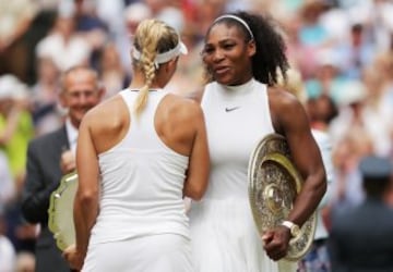 Serena Williams of The United States and Angelique Kerber of Germany in conversation as they hold their trophies following The Ladies Singles Final on day twelve of the Wimbledon Lawn Tennis Championships at the All England Lawn Tennis and Croquet Club on