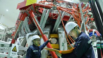 Technical personnel checks the Chinax92s HL-2M nuclear fusion device, known as the new generation of "artificial sun", at a research laboratory in Chengdu, in eastern China's Sichuan province on December 4, 2020. - China successfully powered its "artificial sun" nuclear fusion reactor for the first time, state media reported on December 4, marking a great advance in the country's nuclear power research capabilities. (Photo by STR / AFP) / China OUT