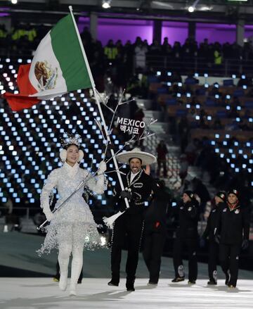 German Madrazo carries the flag of Mexico during the opening ceremony of the 2018 Winter Olympics in Pyeongchang, South Korea, Friday, Feb. 9, 2018. (AP Photo/Vadim Ghirda)