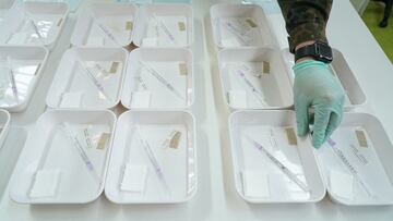 BERLIN, GERMANY - APRIL 15: A member of the Bundeswehr assists in preparing trays of syringes filled with the Pfizer/BioNTech vaccine against Covid-19 at the Arena Berlin mass vaccination center during the third wave of the coronavirus pandemic on April 15, 2021 in Berlin, Germany. After getting off to a slow start Germany has succeeded in picking up the pace of its vaccinations in recent weeks. At the same time authorities are likely to reimpose lockdown measures as infection rates fueled by the B117 variant are rising dramatically. Death rates are also climbing again and the number of available beds in intensive care units is in some regions close to reaching limits. (Photo by Sean Gallup/Getty Images)