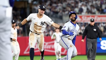 Oct 7, 2024; Bronx, New York, USA; New York Yankees shortstop Anthony Volpe (11) tags Kansas City Royals third base Maikel Garcia (11) in a round down in the fourth inning during game two of the ALDS for the 2024 MLB Playoffs at Yankee Stadium. Mandatory Credit: Vincent Carchietta-Imagn Images