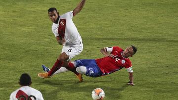Peru's Miguel Trauco, left, and Chile's Fabián Orellana battle for the ball during a qualifying soccer match for the FIFA World Cup Qatar 2022 in Santiago, Chile, Friday, Nov. 13, 2020. (AP Photo/Esteban Felix)