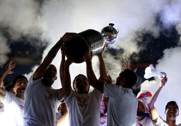 River Plate's Jonathan Maidana, Leonardo Ponzio, and their coach, Marcelo Gallardo (C) celebrate with the Copa Libertadores trophy after beating Boca Juniors in Madrid on December 9, in Buenos Aires, Argentina, December 23, 2018. 