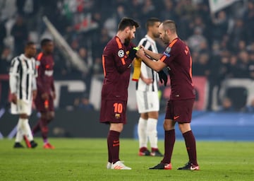 Iniesta hands Messi the captain's armband.