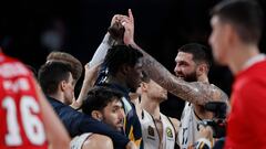 Real Madrid's French center #17 Vincent Poirier and teammates celebrate victory at the end of the Euroleague round 23 basketball match between Real Madrid Baloncesto and Olympiacos Piraeus at the Wizink Center Arena in Madrid on January 25, 2024.