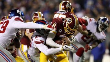 LANDOVER, MD - JANUARY 01: Quarterback Kirk Cousins #8 of the Washington Redskins is sacked by defensive back Leon Hall #25 and outside linebacker Devon Kennard #59 of the New York Giants in the third quarter at FedExField on January 1, 2017 in Landover, Maryland. Patrick Smith/Getty Images/AFP
== FOR NEWSPAPERS, INTERNET, TELCOS & TELEVISION USE ONLY ==