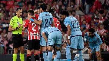 Spanish referee Jose Maria Sanchez shows a yellow card to Athletic Bilbao's Spanish midfielder #21 Ander Herrera during the Spanish league football match between Athletic Club Bilbao and CA Osasuna at the San Mames stadium in Bilbao on May 11, 2024. (Photo by ANDER GILLENEA / AFP)