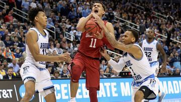 PITTSBURGH, PA - MARCH 15: Trae Young #11 of the Oklahoma Sooners reacts between Jeff Dowtin #11 and Fatts Russell #2 of the Rhode Island Rams in the second half of the game during the first round of the 2018 NCAA Men&#039;s Basketball Tournament at PPG PAINTS Arena on March 15, 2018 in Pittsburgh, Pennsylvania.   Rob Carr/Getty Images/AFP
 == FOR NEWSPAPERS, INTERNET, TELCOS &amp; TELEVISION USE ONLY ==