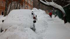 A man walks past cars covered with snow after heavy snowfall in Moscow, Russia December 15, 2023. REUTERS/Maxim Shemetov