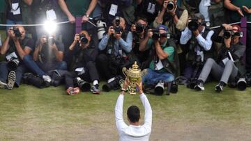 TOPSHOT - Serbia&#039;s Novak Djokovic holds the winner&#039;s trophy after beating Switzerland&#039;s Roger Federer during their men&#039;s singles final on day thirteen of the 2019 Wimbledon Championships at The All England Lawn Tennis Club in Wimbledon, southwest London, on July 14, 2019. (Photo by WILL OLIVER / POOL / AFP) / RESTRICTED TO EDITORIAL USE