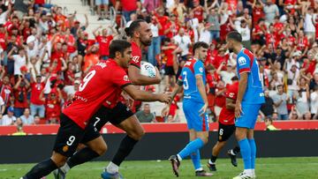 Muriqi corre con el balón con el que le marcó el empate al Atleti en Son Moix mientras Hancko y Ruggeri se lamentan. El drama del Atleti fuera: solo tres victorias
en 13 salidas.