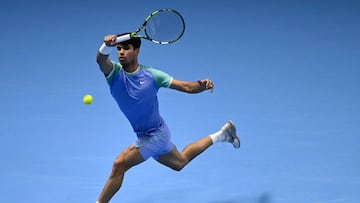 Spain's Carlos Alcaraz hits a return to Norway's Casper Ruud during their match at the ATP Finals tennis tournament in Turin on November 11, 2024. (Photo by Marco BERTORELLO / AFP)
