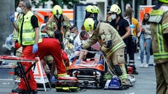 Rescue workers work at the site where one person was killed and eight injured when a car drove into a group of people in the Charlottenburg district.