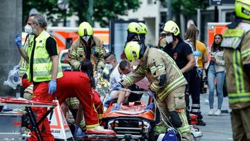 Rescue workers work at the site where one person was killed and eight injured when a car drove into a group of people in the Charlottenburg district.