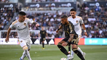 Apr 6, 2024; Los Angeles, California, USA; LAFC forward Denis Bouanga (99) dribbles against LA Galaxy forward Gabriel Pec (11) during the first half at BMO Stadium. Mandatory Credit: Jonathan Hui-USA TODAY Sports