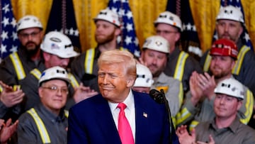 FILE PHOTO: U.S. President Donald Trump reacts next to coal industry workers, on the day he signs energy-related executive orders at the White House in Washington, D.C., U.S., April 8, 2025. REUTERS/Nathan Howard/File Photo