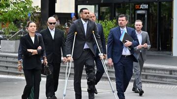 Australian tennis player Nick Kyrgios (C) arrives on crutches to the magistrate's court in Canberra on February 3, 2023. - Kyrgios will try to have an assault charge against him dismissed on mental health grounds. (Photo by SAEED KHAN / AFP) (Photo by SAEED KHAN/AFP via Getty Images)