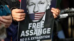 FILE PHOTO: A supporter of WikiLeaks founder Julian Assange holds a sign, on the day the High Court is set to rule on whether Julian Assange can appeal against extradition from Britain to the United States, in London, Britain, March 26, 2024. REUTERS/Toby Melville/File Photo