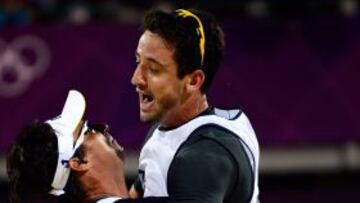 Brazil's Pedro Cunha and Ricardo Santoscelebrate at the end of the men's Beach Volleyball match against Spainx92s Pablo Herrera and Adrian Gaviria on the Centre Court Stadium in Horse Guards Parade on London on August 3, 2012, for the London 2012 Olympic Games. AFP PHOTO / DANIEL GARCIA
