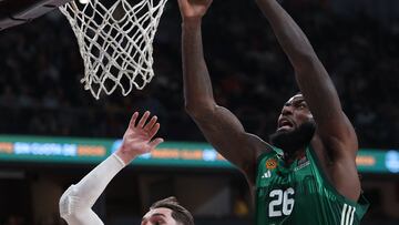 Panathinaikos Athens' French center #26 Mathias Lessort dunks over Real Madrid's Croatian forward #11 Mario Hezonja during the Euroleague basketball match between Real Madrid Baloncesto and Panathinaikos BC at the WiZink Center arena, on February 29, 2024. (Photo by Thomas COEX / AFP)