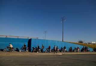 Electric motorcycle riders wait in line to enter a special bus to transport two wheel vehicles as Cubans face one of the worst fuel shortages in recent years due to the U.S. tightening of oil supply blockade, in Havana, Cuba February 13, 2026. REUTERS/Norlys Perez