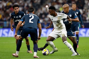 Pachuca's Argentine defender #2 Sergio Barreto and Mexican defender #24 Luis Rodriguez vie for the ball against Real Madrid's Brazilian forward #7 Vinicius Junior during the 2024 FIFA Intercontinental Cup final football match between Spain's Real Madrid and Mexico's Pachuca at the Lusail Stadium in Doha on December 18, 2024. (Photo by KARIM JAAFAR / AFP)