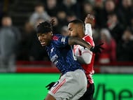 Arsenal's English defender #20 Noni Madueke battles for the ball with Brentford's English defender #03 Rico Henry during the English Premier League football match between Brentford and Arsenal at the Gtech Community Stadium in London on February 12, 2026. (Photo by Glyn KIRK / AFP) / RESTRICTED TO EDITORIAL USE. No use with unauthorized audio, video, data, fixture lists, club/league logos or 'live' services. Online in-match use limited to 120 images. An additional 40 images may be used in extra time. No video emulation. Social media in-match use limited to 120 images. An additional 40 images may be used in extra time. No use in betting publications, games or single club/league/player publications. /