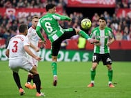 Real Betis' Spanish midfielder #08 Pablo Fornals jumps for the ball during the Spanish league football match between Sevilla FC and Real Betis at Ramon Sanchez Pizjuan Stadium in Seville on November 30, 2025. (Photo by CRISTINA QUICLER / AFP)