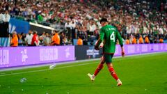 Jun 15, 2023; Las Vegas, Nevada, USA; Mexico midfielder Edson Alvarez (4) picks up trash off the field during the second half against the USA at Allegiant Stadium. Mandatory Credit: Lucas Peltier-USA TODAY Sports