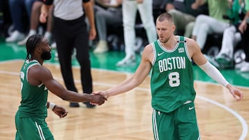 BOSTON, MASSACHUSETTS - JUNE 17: Jaylen Brown #7 and Kristaps Porzingis #8 of the Boston Celtics celebrate after a pladuring the fourth quarter of Game Five of the 2024 NBA Finals against the Dallas Mavericks at TD Garden on June 17, 2024 in Boston, Massachusetts. NOTE TO USER: User expressly acknowledges and agrees that, by downloading and or using this photograph, User is consenting to the terms and conditions of the Getty Images License Agreement.   Adam Glanzman/Getty Images/AFP (Photo by Adam Glanzman / GETTY IMAGES NORTH AMERICA / Getty Images via AFP)