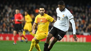 Barcelona's German midfielder #22 Ilkay Gundogan challenges Valencia's Spanish defender #03 Cristhian Mosquera during the Spanish league football match between Valencia CF and FC Barcelona at the Mestalla stadium in Valencia on December 16, 2023. (Photo by JOSE JORDAN / AFP)