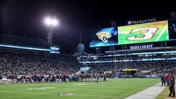 JACKSONVILLE, FLORIDA - JANUARY 07: Players pray as the scoreboard displays a number three support of Buffalo Bills safety Damar Hamlin prior to a game against the Tennessee Titans at TIAA Bank Field on January 07, 2023 in Jacksonville, Florida. Hamlin suffered cardiac arrest during the Bills' Monday Night Football game against the Cincinnati Bengals and remains in intensive care.   Mike Carlson/Getty Images/AFP (Photo by Mike Carlson / GETTY IMAGES NORTH AMERICA / Getty Images via AFP)