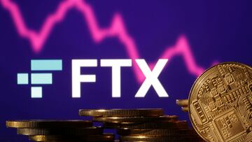 Representations of cryptocurrencies are seen in front of displayed FTX logo and decreasing stock graph in this illustration taken November 10, 2022. REUTERS/Dado Ruvic/Illustration