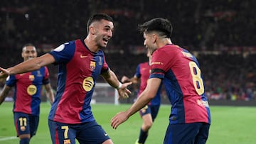 Barcelona's Spanish midfielder #08 Pedri celebrates with Barcelona's Spanish forward #07 Ferran Torres, after scoring the opening goal during their Spanish Cup, Copa del Rey (King's Cup) final football match between FC Barcelona and Real Madrid CF at La Cartuja stadium in Seville on April 26, 2025. (Photo by Josep LAGO / AFP)
