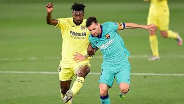 Barcelona&#039;s Argentine forward Lionel Messi (R) challenges Villarreal&#039;s Cameroonian midfielder Andre-Frank Zambo Anguissa during the Spanish League football match between Villarreal and Barcelona at the Madrigal stadium in Villarreal on July 5, 2