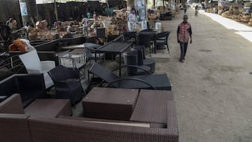 In this photograph taken on August 27, 2020, a man walks past cane woven household items on display at Nigeria&#039;s largest cane &#039;village&#039; under the bridge at Mende in the Maryland District of Lagos. - Cane craft in Nigeria, Africa&#039;s most