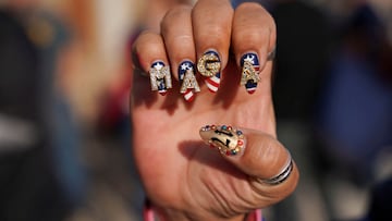 A supporter of Republican presidential nominee former U.S. President Donald Trump shows her "Make America Great Again" (MAGA) themed decorated nails outside the venue on the day of a campaign rally in Pittsburgh, Pennsylvania, U.S., November 4, 2024. REUTERS/Seth Herald TPX IMAGES OF THE DAY