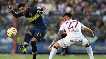 Boca Juniors' forward Mauro Zarate (L) kicks the ball next to Lanus' defender Gabriel Carrasco during their Argentina First Division Superliga football match at La Bombonera stadium, in Buenos Aires, on February 17, 2019. (Photo by Alejandro PAGNI / AFP)