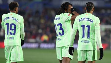 Barcelona's French defender #23 Jules Kounde celebrates scoring the opening goal flanked by Barcelona's Spanish forward #19 Lamine Yamal and Barcelona's Brazilian forward #11 Raphinha during the Spanish league football match between Getafe CF and FC Barcelona at the Coliseum Alfonso Perez stadium in Getafe on January 18, 2025. (Photo by Thomas COEX / AFP)