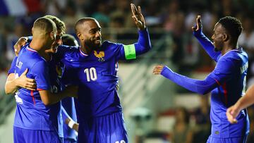 French forward #10 ALexandre LAcazette (C) celebrates with his teammates after scoring his team's fifth goal during the U23 friendly football match between France and Dominican Republic at Mayol Stadium in Toulon, south-eastern France, on July 11, 2024, in preparation for the Paris 2024 Olympic Games. (Photo by CLEMENT MAHOUDEAU / AFP)