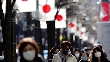Pedestrians wearing protective masks, amid the coronavirus disease (COVID-19) outbreak, make their way at Ginza shopping district which closed to cars on Sunday in Tokyo, Japan, January 10, 2021. REUTERS/Kim Kyung-Hoon