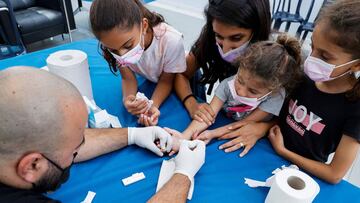 Israeli children undergo Covid-19 antibody testing in the coastal city of Netanya on August 22, 2021, before the start of the new school year. - Israel launched antibody testing for children aged as young as three, seeking information on the number of unv